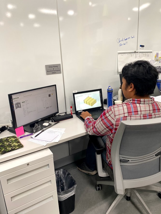 Our Manufacturing Engineering Intern working at his work station.