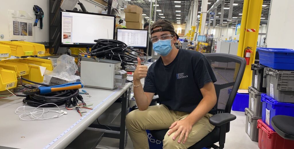 Manufacturing intern Dylan Janssen sitting at his workspace.